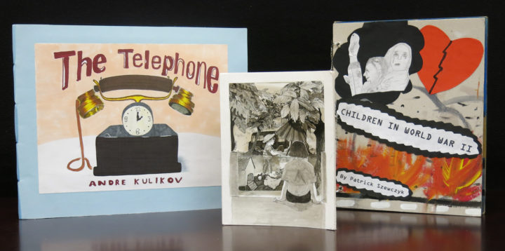 The city winners of the 2020 Ezra Jack Keats Bookmaking Competition are: (L to R): The Telephone by Andre Kulikov (Grade 8, IS 98-The Bay Academy for the Arts & Sciences, Brooklyn, NY), The Comforts of Home by Nadine Baidan (Grade 11, LaGuardia High School, New York, NY) and World War II, by Patrick Szewczyk (Grade 4, PS 63Q-The Old South, Queens, NY).